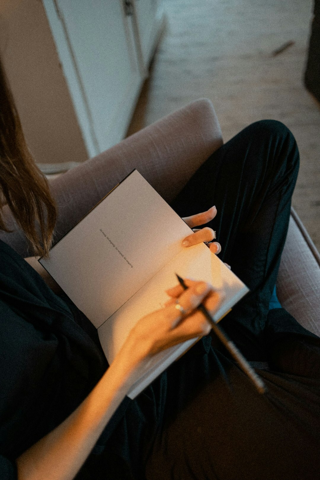 man writing in journal